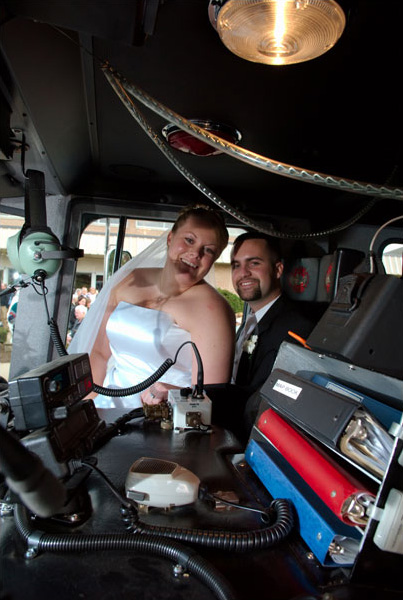 In their firetruck ready to leave for their reception.