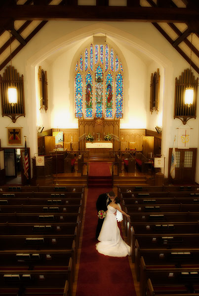 A romantic portrait of the bride and groom inside the church.