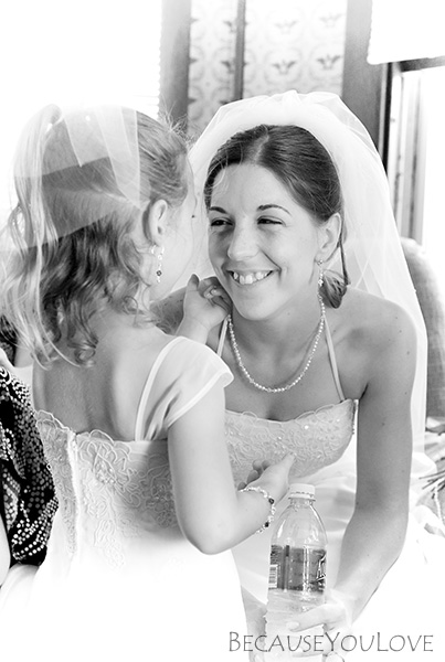 A photo-journalistic image of the bride with the flower girl