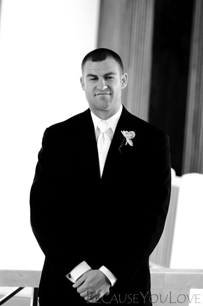 groom watches wedding procession
