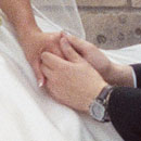 Close up of photograph of bride and groom holding hands