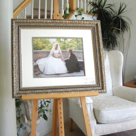 Framed photograph of groom proposing to bride