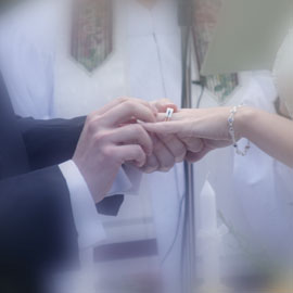the bride and groom exchange rings in this photograph