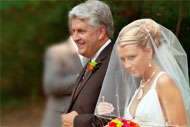 journalistic wedding photographer captures the bride and her father walking to the wedding ceremony