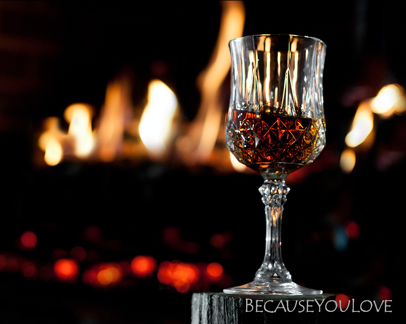 artistic photograph of bourbon by the fire