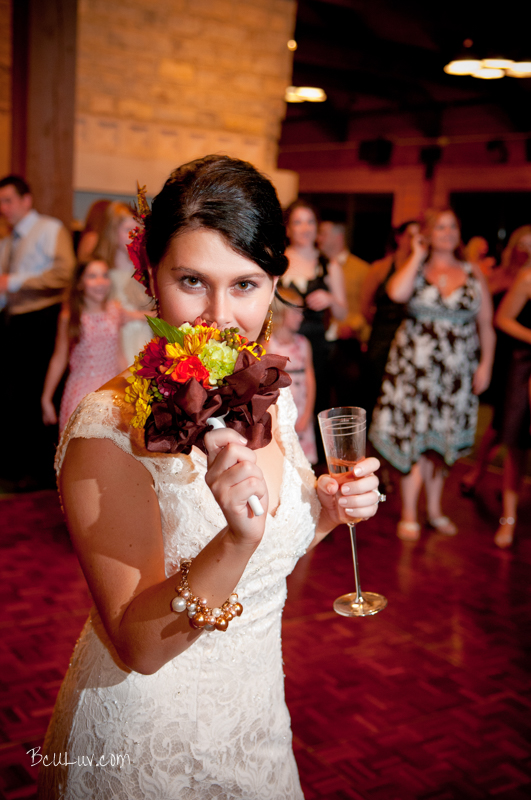 An intense bride is ready to toss the flowers at her reception