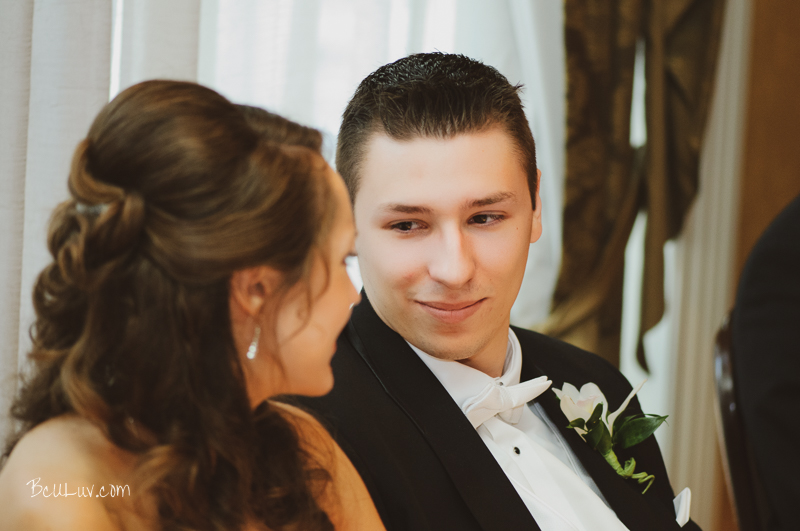 A loving groom gazes at his bride