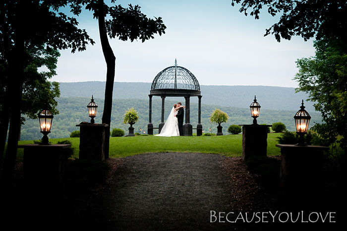 Bride and groom under a gazebo during their wedding.